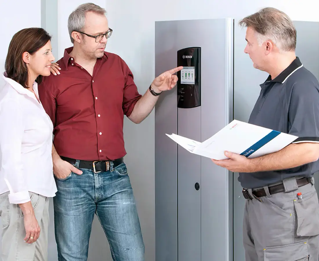 Homeowners discussing their battery storage system with a technician