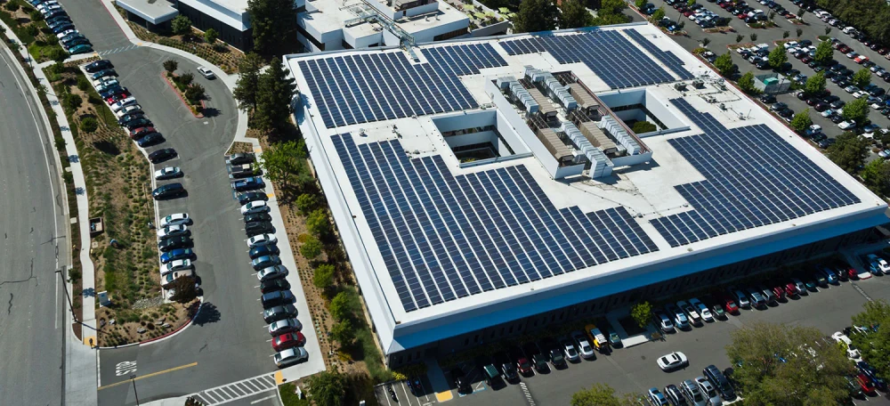 Aerial view of a large commercial rooftop solar installation