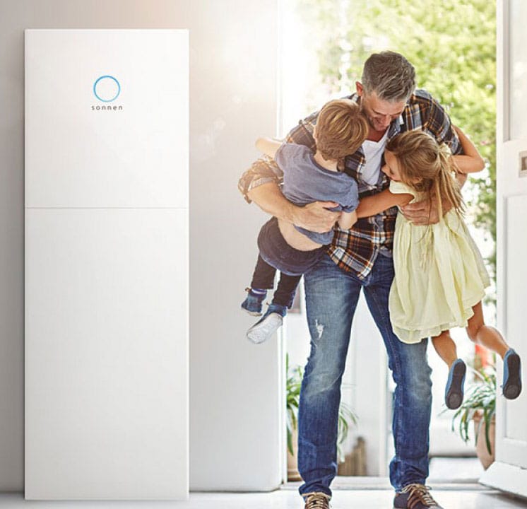 sonnen_batteries_new Father is hugging children standing beside Sonnen Battery