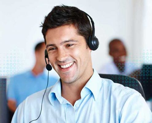 a guy giving technical support on call with a smile